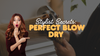 Stylist secrets thumbnail with woman pointing in surprise and text reading Perfect Blow Dry over background of round brush and blow dryer.