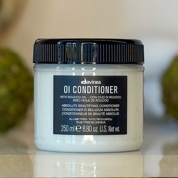 Davines OI Conditioner jar on a neutral background
