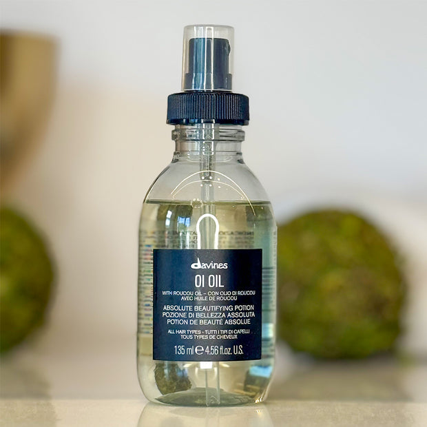 Bottle of Davines OI Oil on a neutral background
